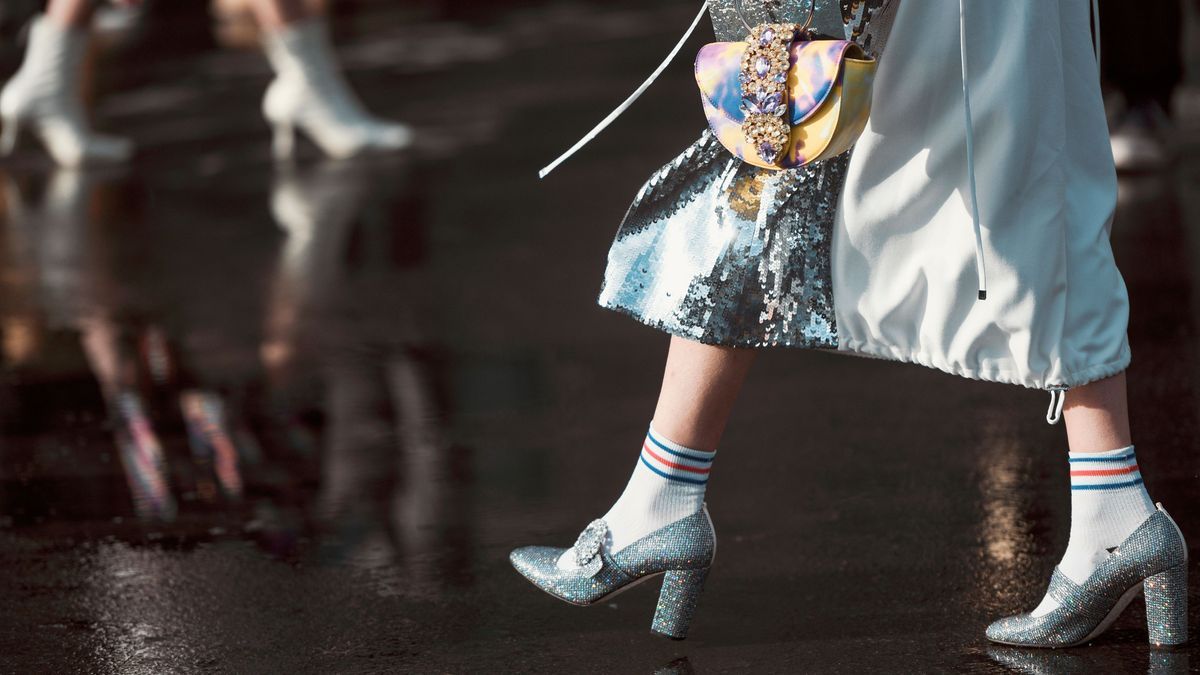 Paris, France – March 3, 2020: Colorful handbag with diamond details and silver glittery high heel shoes - streetstylefw20