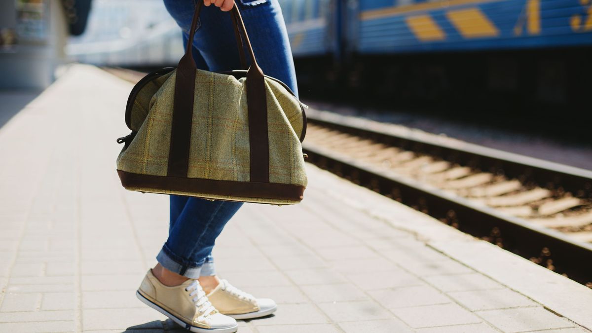 Woman holding a bag at a train station