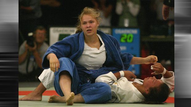 
                <strong>Mit Judo fing alles an</strong><br>
                Rouseys Karriere begann eigentlich mit Judo. Im Alter von 17 Jahren qualifiziert sich die Amerikanerin für die Olympischen Spiele 2004 in Athen und gewann bei den Junioren-Weltmeisterschaften die Goldmedaille. Ihr Debüt als MMA-Kämpferin gab Rousey 2010.
              