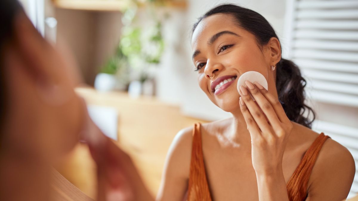 Latin beautiful woman using cotton pads for cleaning face 