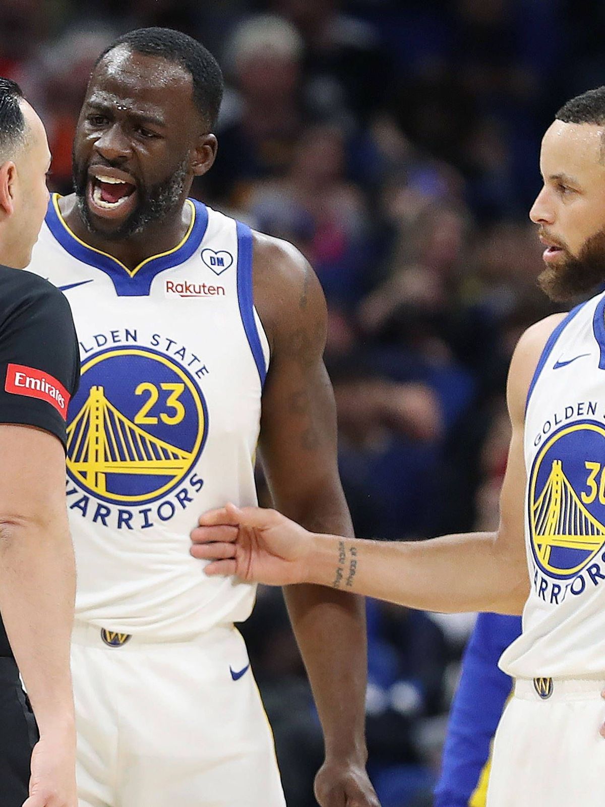SPORTS-BKN-WARRIORS-MAGIC-1-OS The Golden State Warriors Draymond Green (23) screams at game official Ray Acosta (54) as teammate Stephen Curry (30) steps in at right during action against the Orla...