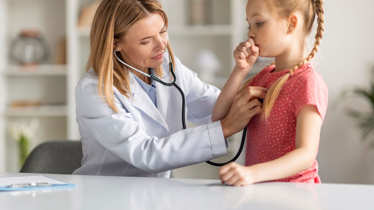 Pediatrician Lady With Stethoscope Listening Lungs Of Coughing Little Girl During Checkup