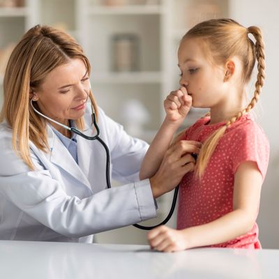 Pediatrician Lady With Stethoscope Listening Lungs Of Coughing Little Girl During Checkup