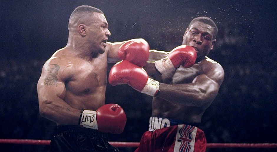 
                <strong>Mike Tyson</strong><br>
                Nach drei Jahren durfte Tyson das Gefängnis auf Bewährung verlassen und kehrte schnell in den Ring zurück. Im März 1996 besiegte er Frank Bruno (Foto) und kürte sich zum zweiten Mal zum Weltmeister. Im Herbst desselben Jahres besiegte er Bruce Seldon. Auf dem Weg zur Siegesfeier wurde der Rapper Tupac erschossen, der ein Freund von Tyson war.
              