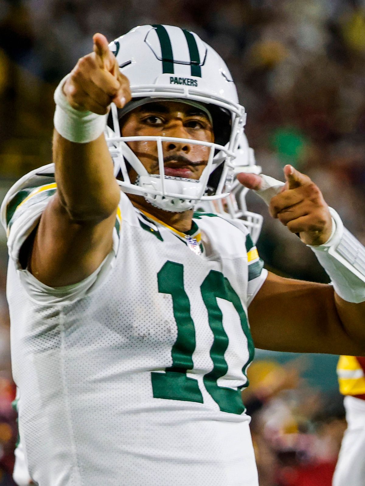 Green Bay Packers quarterback Jordan Love reacts after running for a first down in the first half of the NFL, American Football Herren, USA game between the Washington Commanders and the Green Bay ...