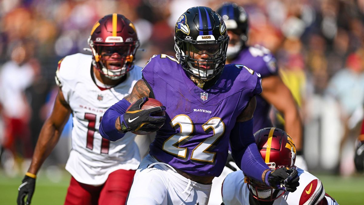 Baltimore Ravens running back Derrick Henry (22) scores a 3 yard rushing touchdown in front of Washington Commanders safety Jeremy Chinn (11) during the first half at M&T Bank Stadium in Baltimore,...