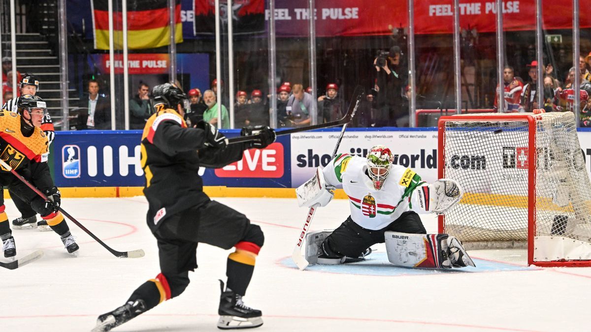 ODENSE, DENMARK - MAY 10: Dominik Kahun of Germany scores a goal against goalkeeper Bence Balizs of Hungary during the 2025 Ice hockey, Eishockey World Championship, WM, Weltmeisterschaft match bet...