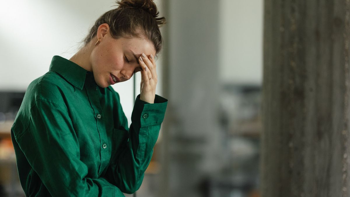 Young sad woman in office, having problem.