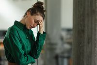 Young sad woman in office, having problem.