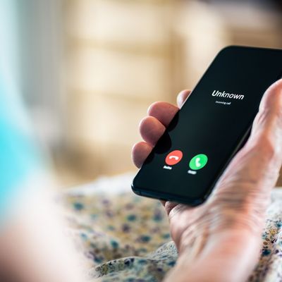 Old woman and phone call with hidden mobile number. Senior mature lady and fraud and scam caller. Love and romance hoax. Holding smartphone in hand. Catfish or scammer. Phishing concept.