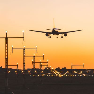 Airplane landing at sunset, silhouette