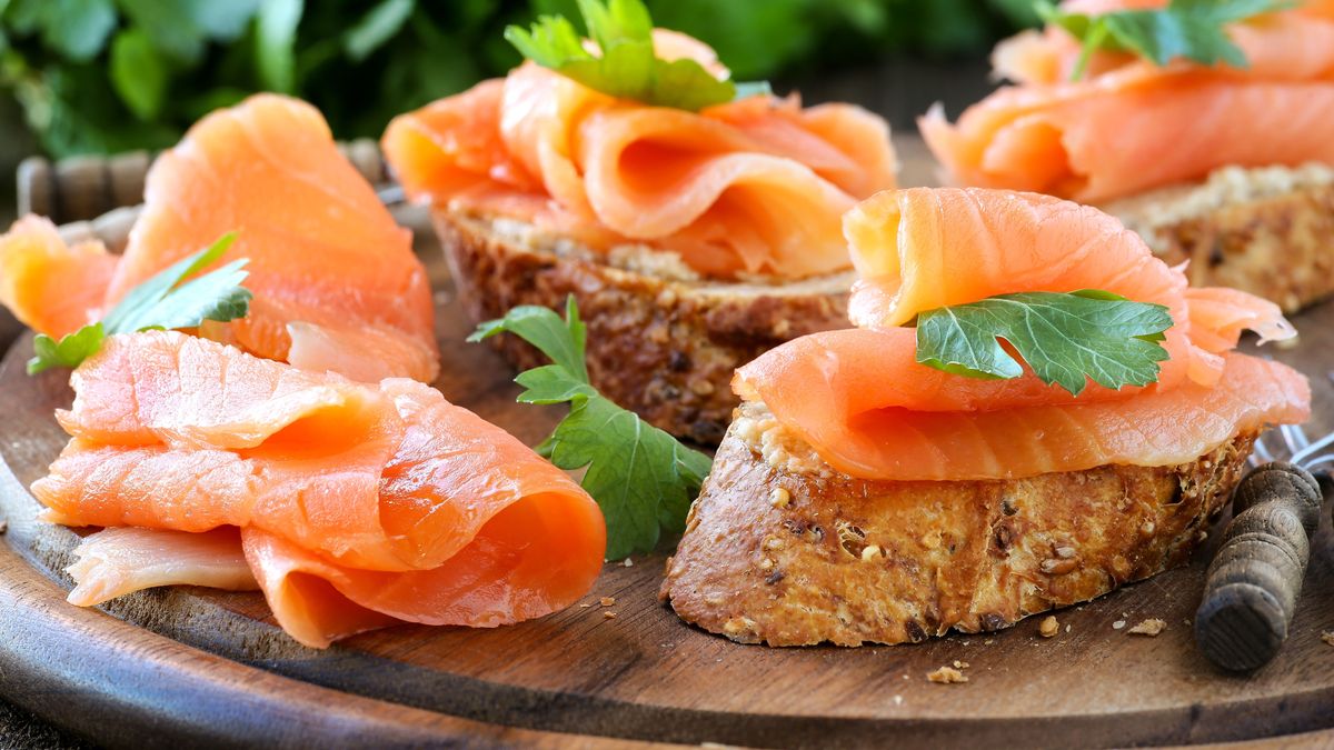 Smoked salmon free canape parsley leaf on wood