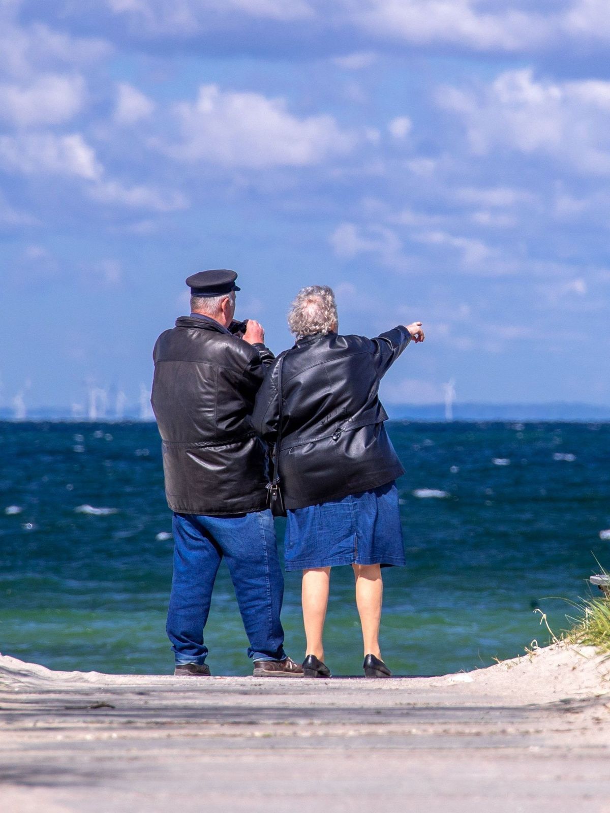 Ein Rentnerpaar steht am Timmendorfer Strand.