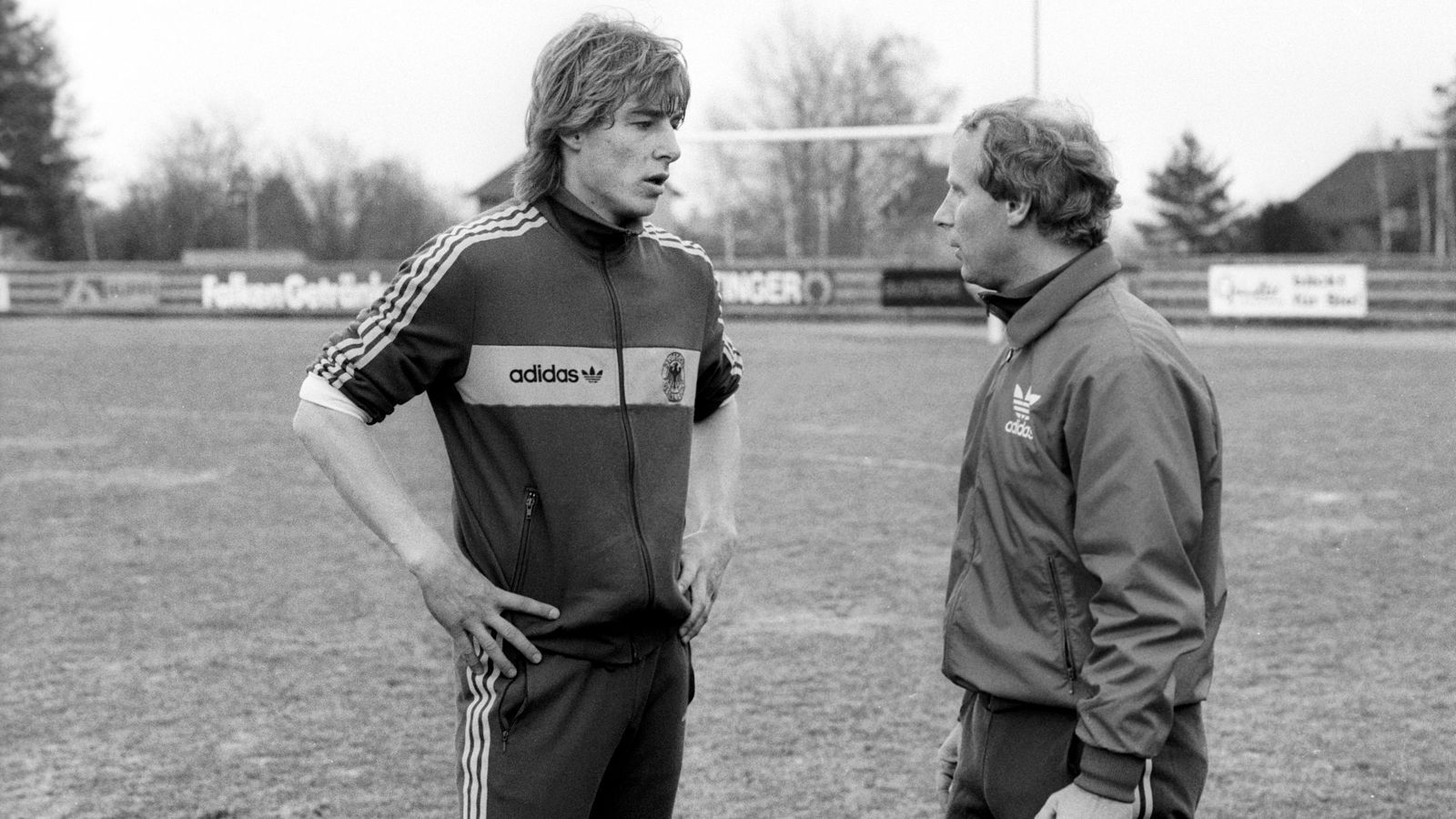 
                <strong>Berti Vogts war erster Trainer</strong><br>
                Erster Trainer war von 1979 bis 1990 Berti Vogts (re., hier mit Jürgen Klinsmann). Sein Premieren-Spiel mit der neuen Mannschaft ging direkt verloren, in Polen unterlag der deutsche Nachwuchs am 10. Oktober 1979 mit 0:1. Ein unglücklicher Start einer dennoch langen und erfolgreichen Amtszeit. Erst als Vogts elf Jahre später Nachfolger von Franz Beckenbauer als Nationaltrainer wurde, gab er den Posten ab.
              