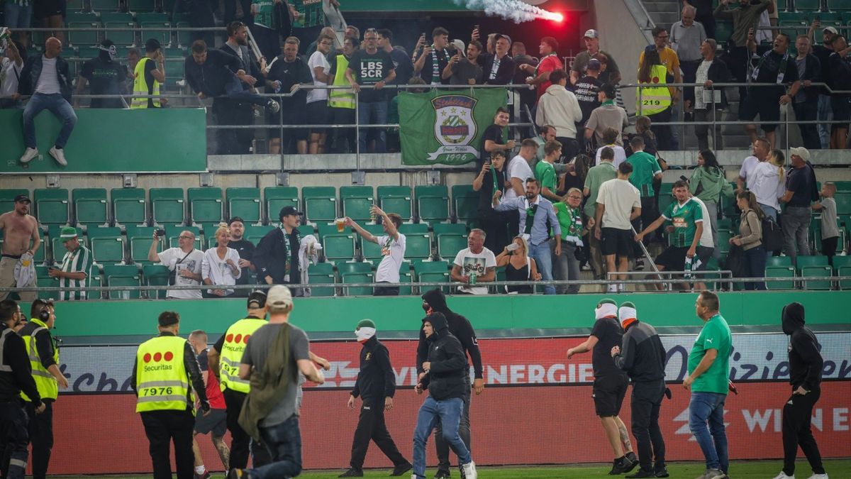 Fans stürmen das Feld, Pyrotechnik fliegt