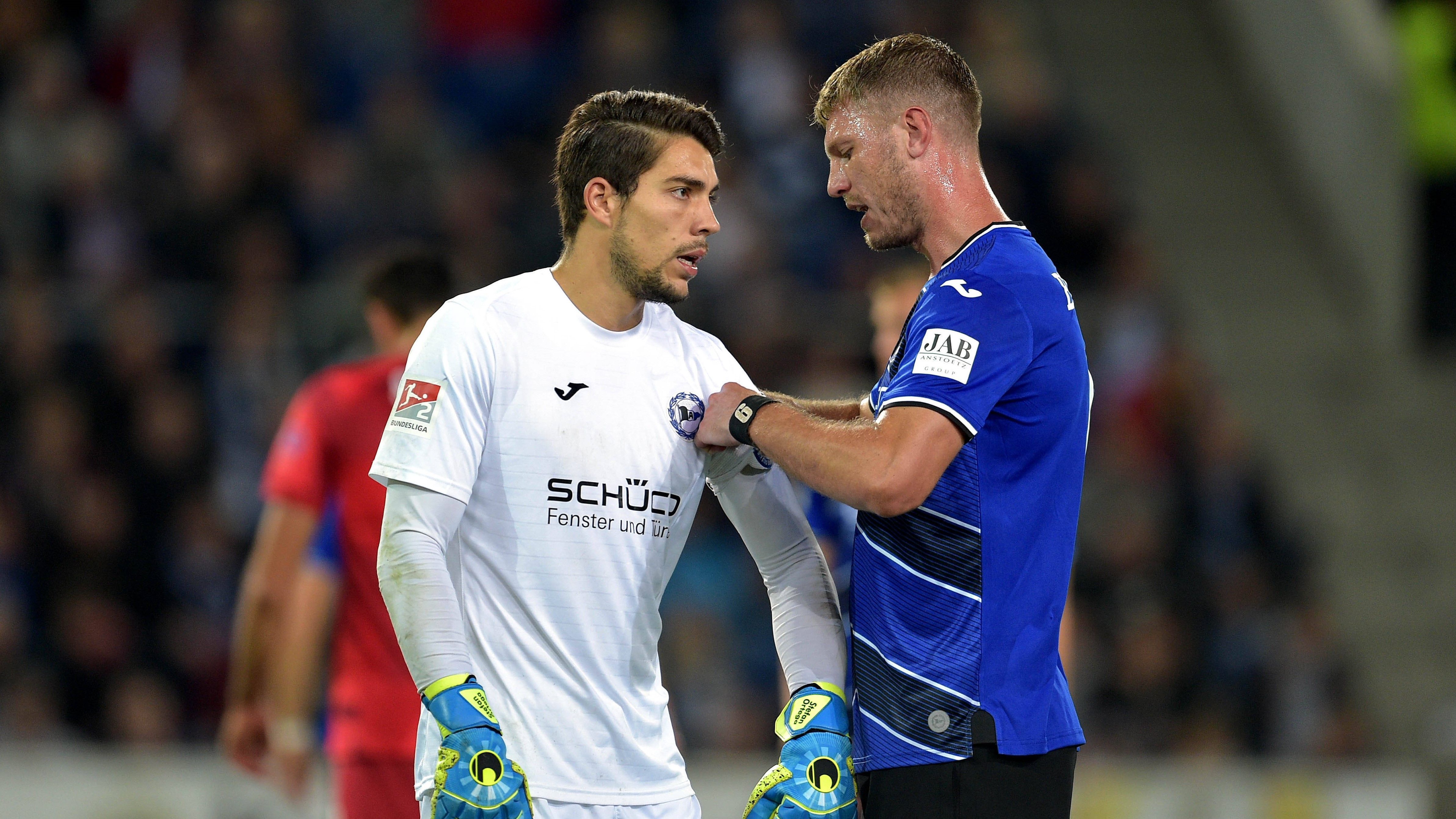 
                <strong>Arminia Bielefeld</strong><br>
                1. Fabian Klos (Kapitän) 2. Stefan OrtegaWeitere Mitglieder: Amos Pieper, Manuel Prietl, Reinhold Yabo 
              