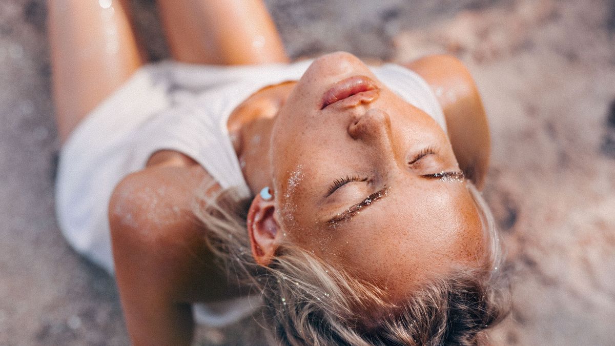 beautiful young woman on the beach close up portrait