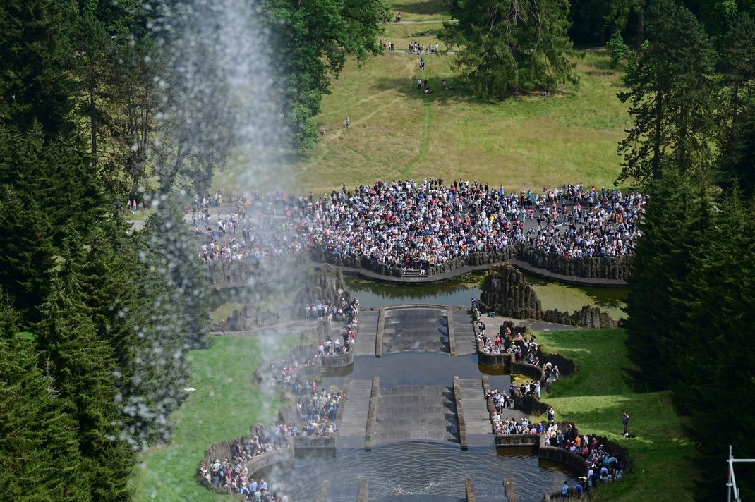 Besucher:innen erfreuen sich in Kassel an den Wasserspielen im Bergpark Wilhelmshöhe, die zum UNESCO-Welterbe erklärt wurden.