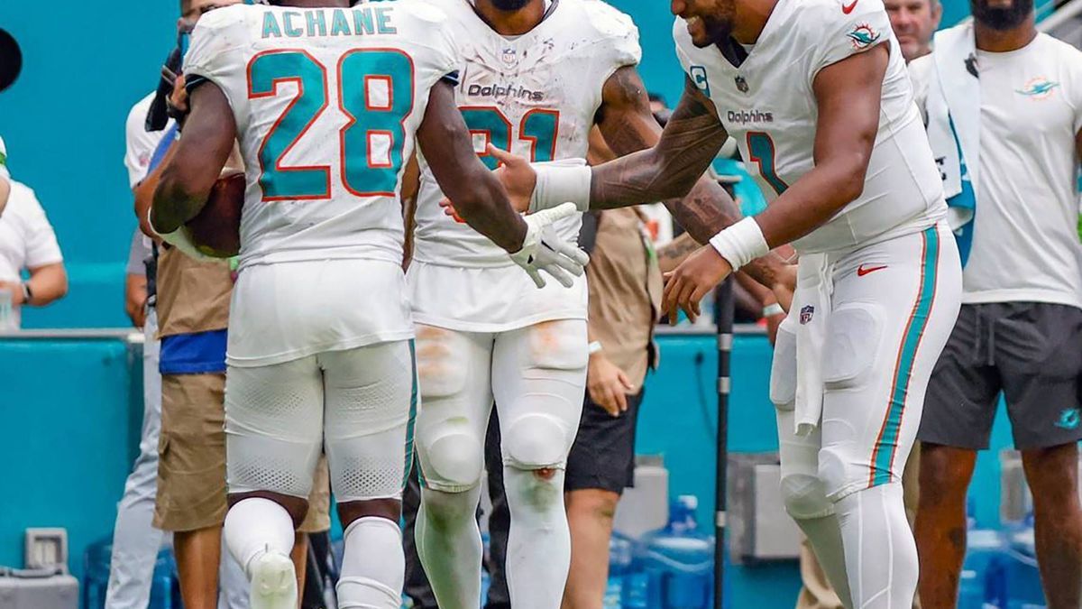 June 25, 2024: Miami Dolphins running back De Von Achane (28) celebrates his touchdown with running back Raheem Mostert (31) and quarterback Tua Tagovailoa (1) in the fourth quarter against the Den...