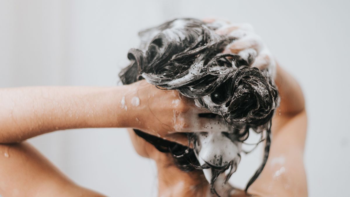 Woman washing hair with shampoo and shower in bathroom, Asian female body and hair care with foam to freshness. Spa and Health care.