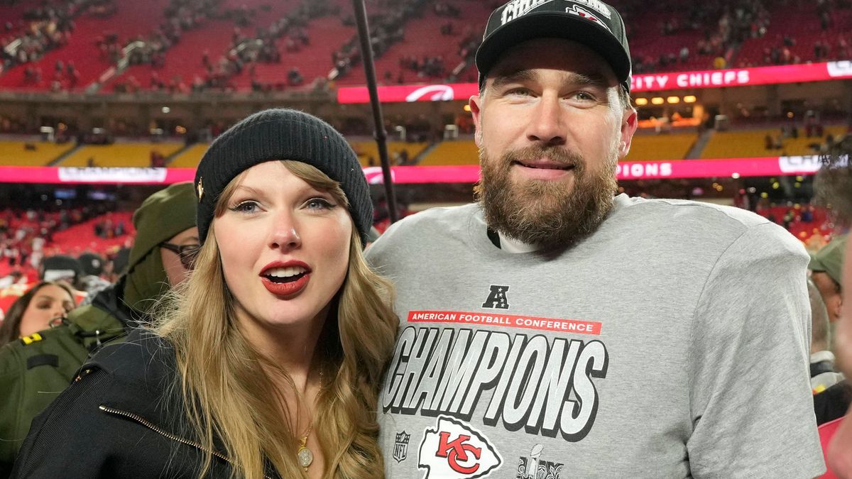 Kansas City Chiefs tight end Travis Kelce and his girlfriend entertainer Taylor Swift stand on the field after the Chiefs defeated the Buffalo Bills 32-29 in the AFC Championship Game at Arrowhead ...