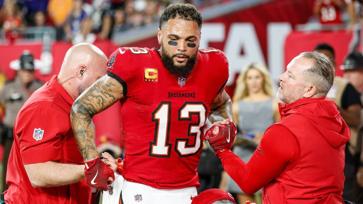 October 21, 2024, Tampa, Florida, USA: Tampa Bay Buccaneers wide receiver Mike Evans (13) is helped by medical staff, while the Baltimore Ravens wait to resume play during the second quarter at Ray...