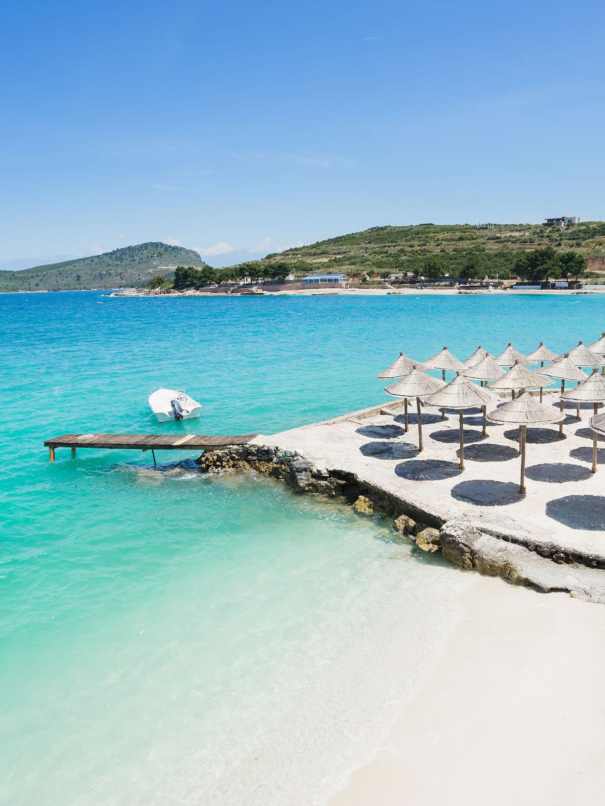 Sunshade umbrellas on the small beautiful Ksamil beach, Albania.