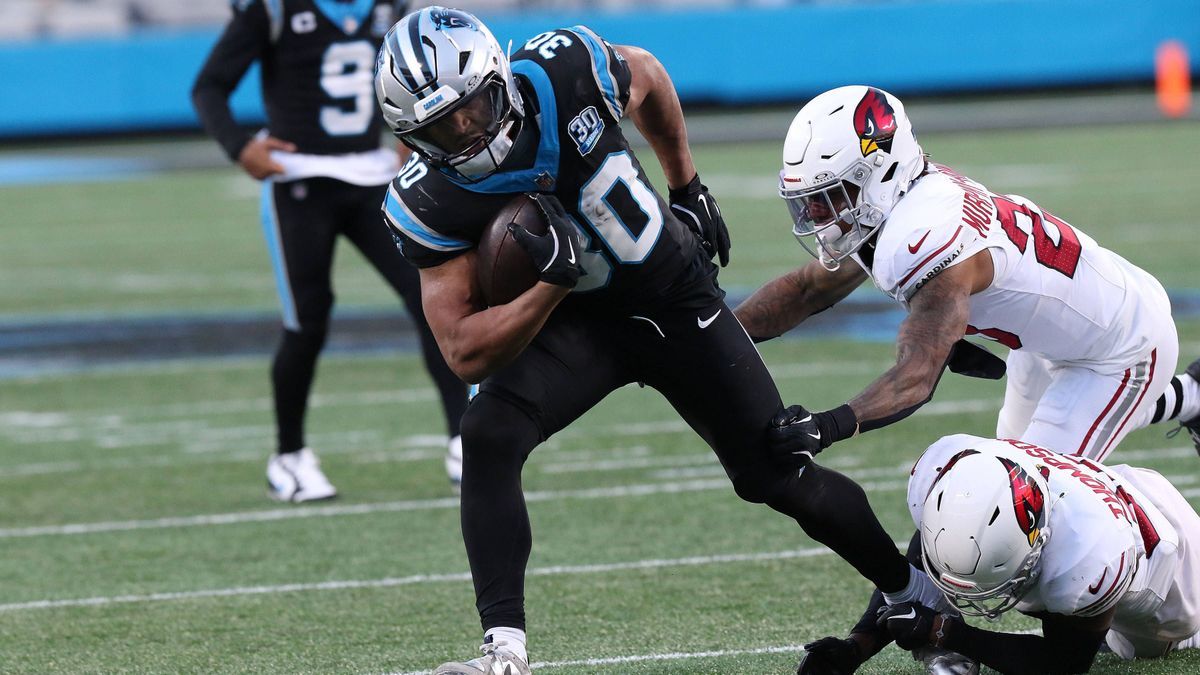 CHARLOTTE, NC - DECEMBER 22: Carolina Panthers running back Chuba Hubbard (30) breaks through the arm tackles of Arizona Cardinals corner back Sean Murphy-Bunting (23) and Arizona Cardinals corner ...