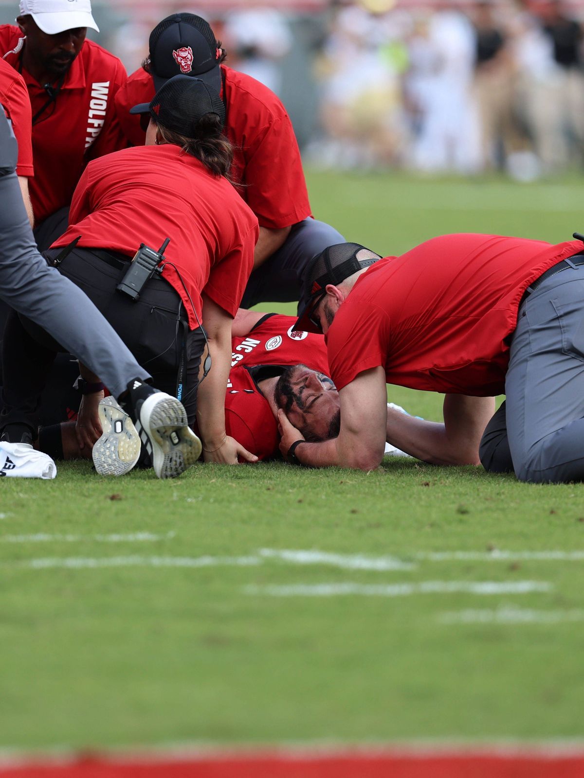 October 5, 2024, Raleigh, North Carolina, USA: NC State trainers delivering care to QB Grayson McCall after hard hit during the ACC Football match between Wake Forest University and NC State at Car...