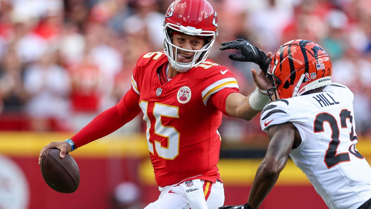 September 15, 2024: Kansas City Chiefs quarterback Patrick Mahomes (15) scrambles during the first half and stiff arms Cincinnati Bengals cornerback Dax Hill (23) at GEHA Field at Arrowhead Stadium...