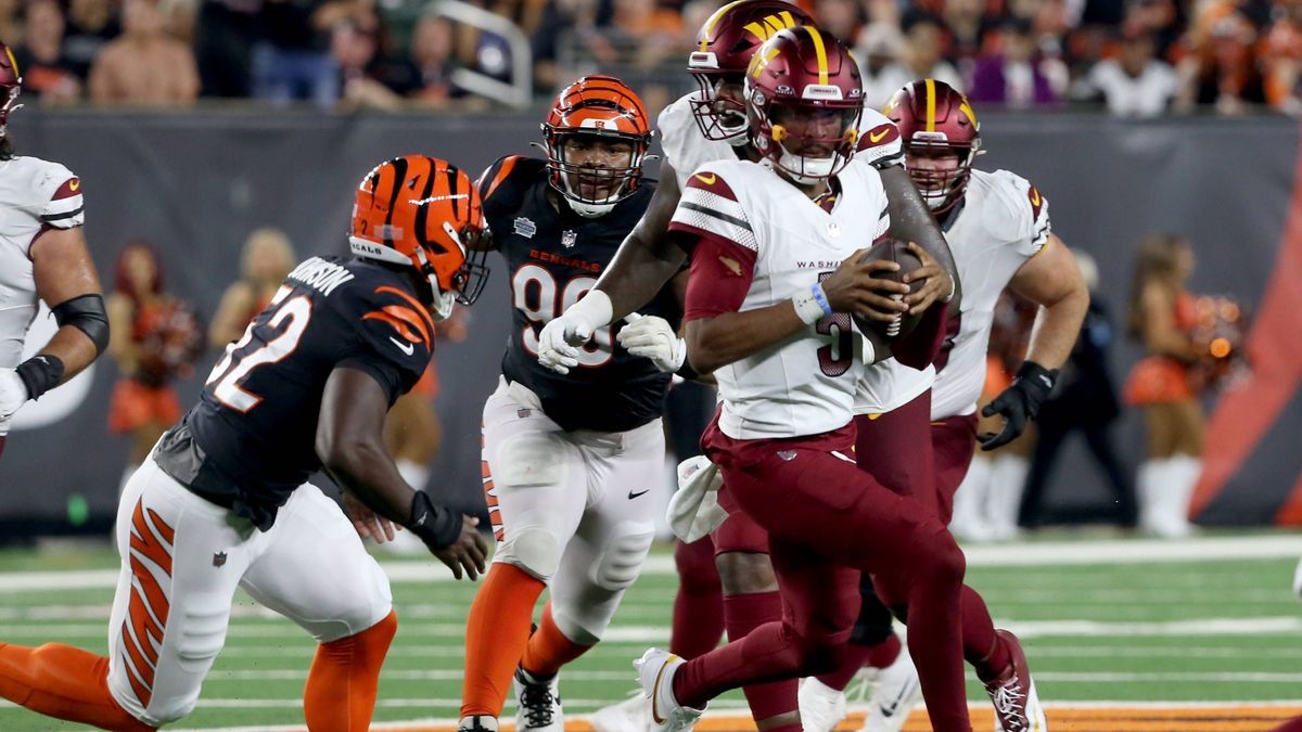 Washington Commanders quarterback Jayden Daniels (5) runs under pressure from the Cincinnati Bengals defense during the second half of play at Paycor Stadium on Monday, September 23, 2024 in Cincin...