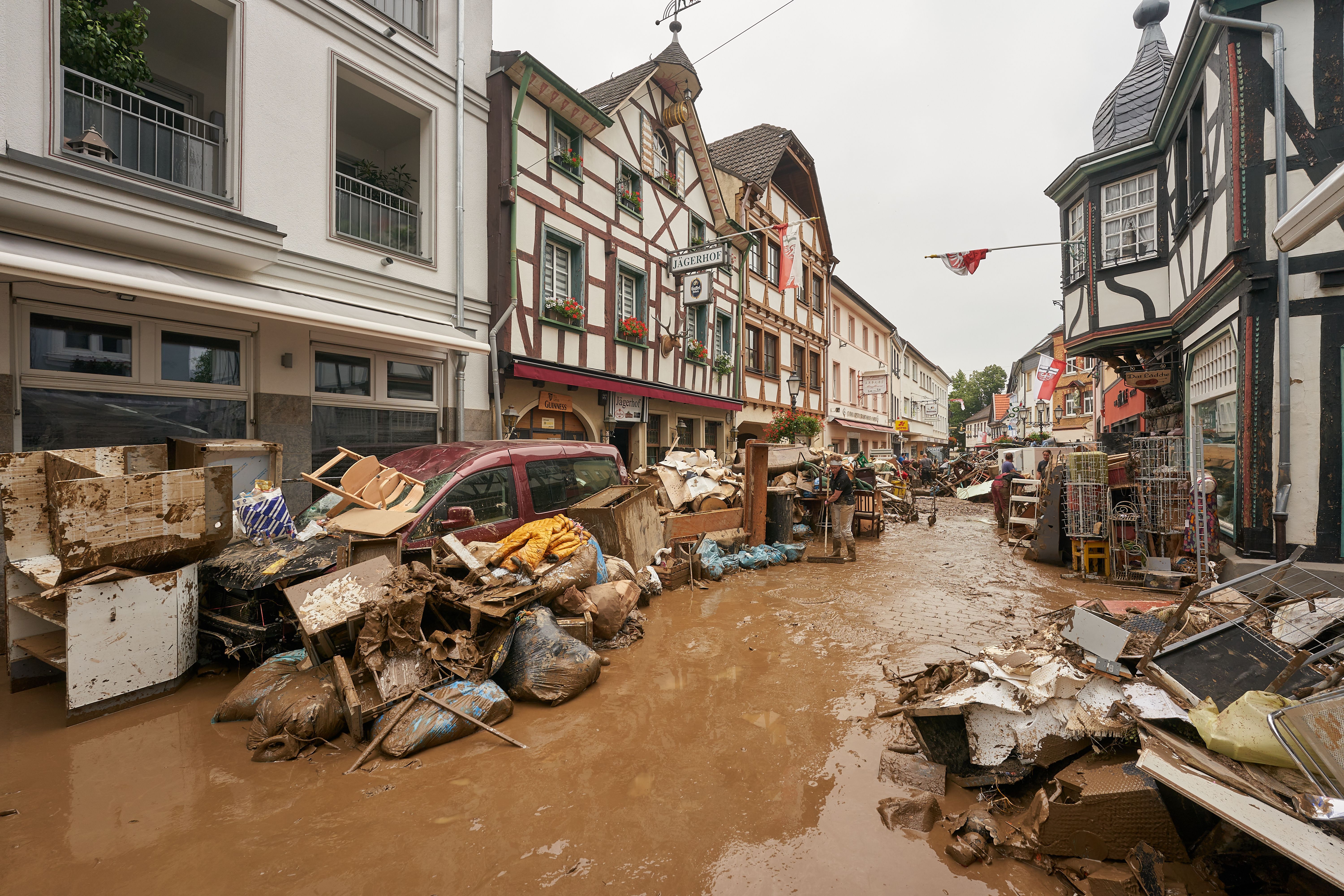 Anwohner und Ladeninhaber versuchten nach der Flut, ihre Häuser vom Schlamm zu befreien und unbrauchbares Mobiliar nach draußen zu bringen.