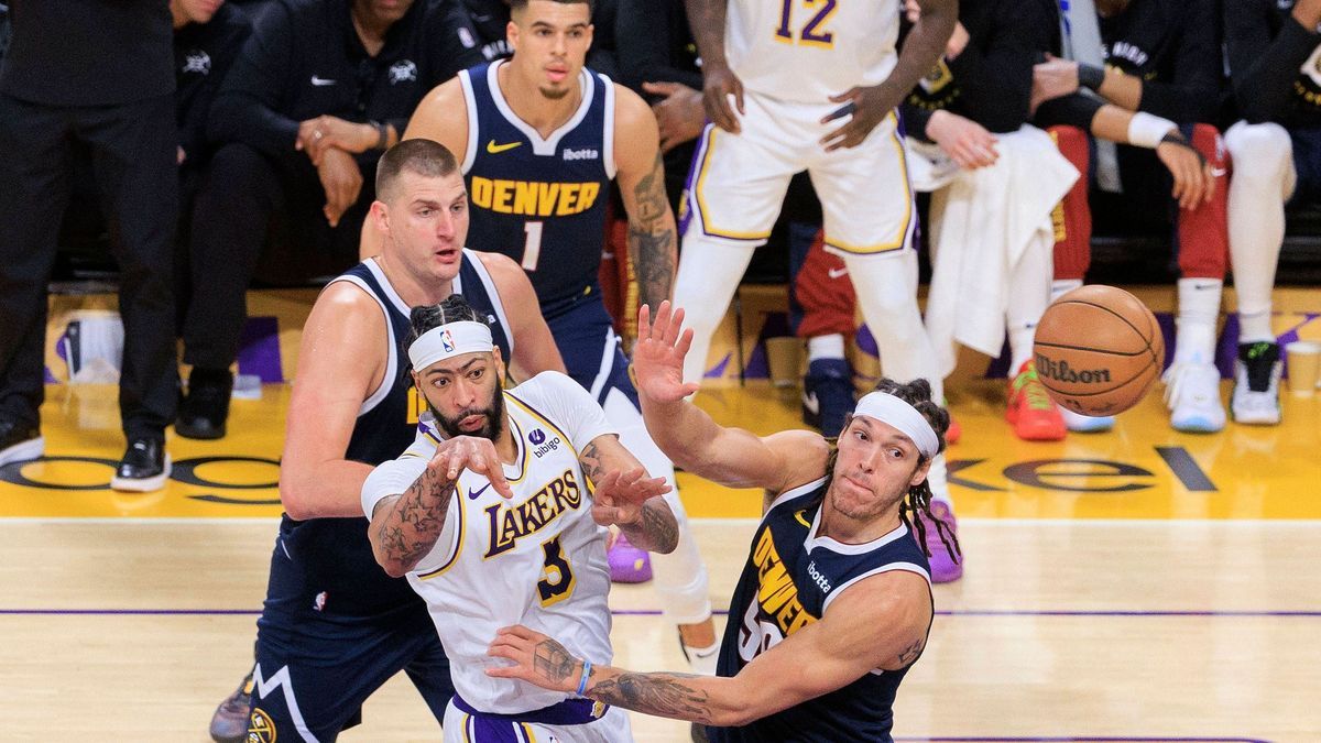 April 27, 2024, Los Angeles, California, USA: Anthony Davis 3 of the Los Angeles Lakers passes the ball past Aaron Gordon 50 of the Denver Nuggets during game four of the Western Conference First R...