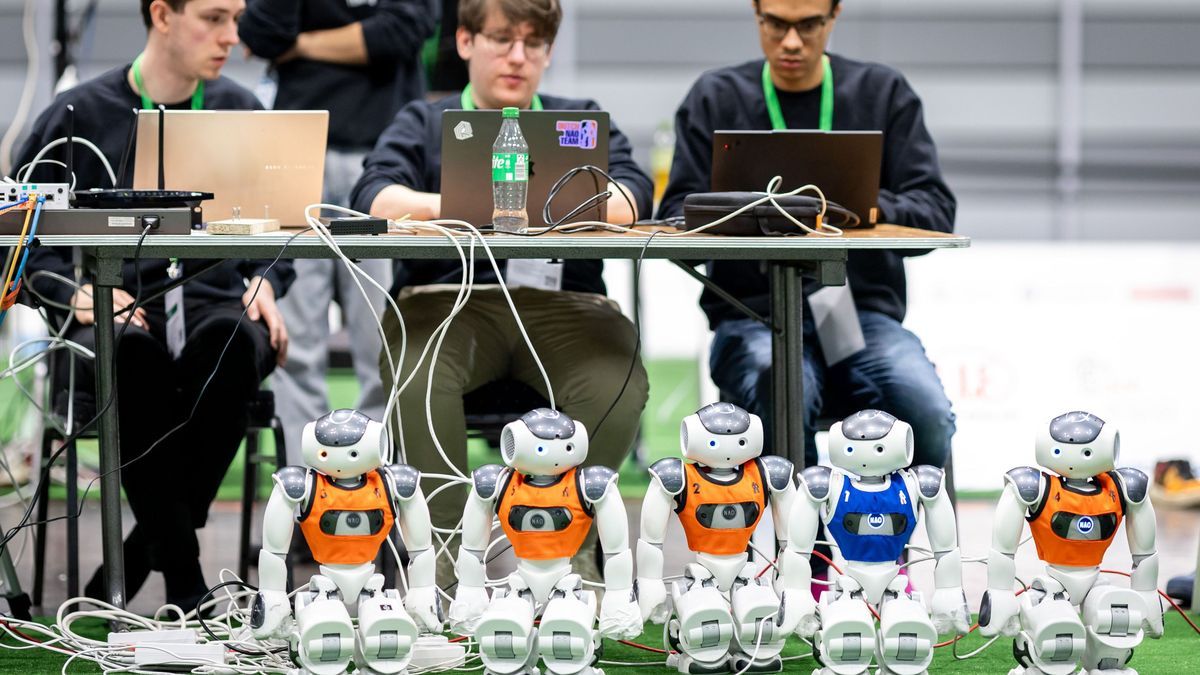 Autonome intelligente Roboter werden während der RoboCup German Open auf dem Nürnberger Messegelände für ein Fußballspiel am Spielfeldrand aufgeladen.