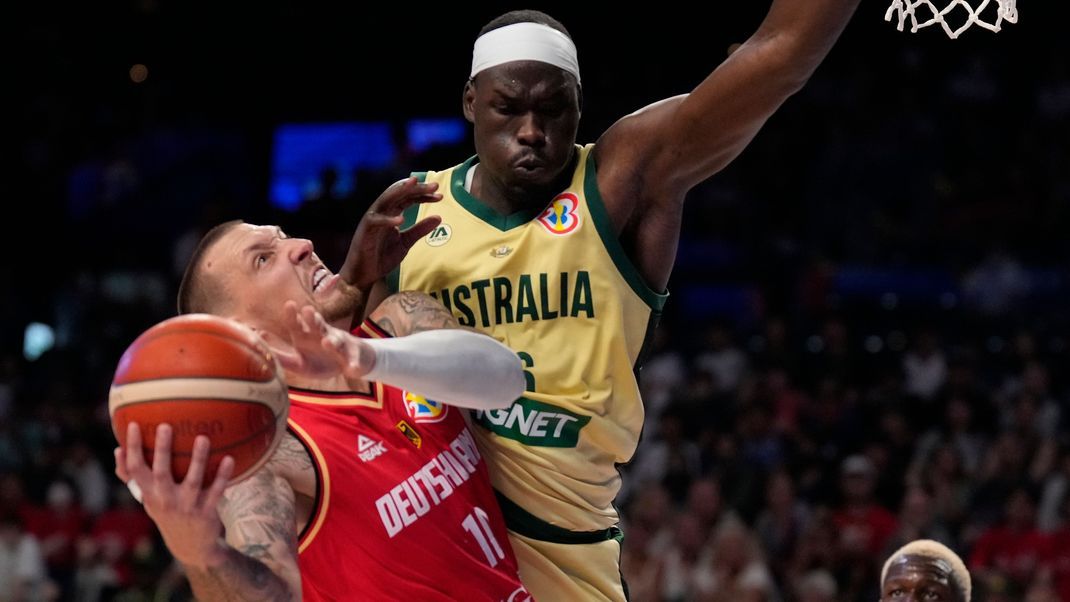 Deutschlands Daniel Theis (l) gegen Australiens Center Duop Reath. Das Team von Trainer Gordon Herbert gewinnt knapp gegen die Australier in der Vorrunde.