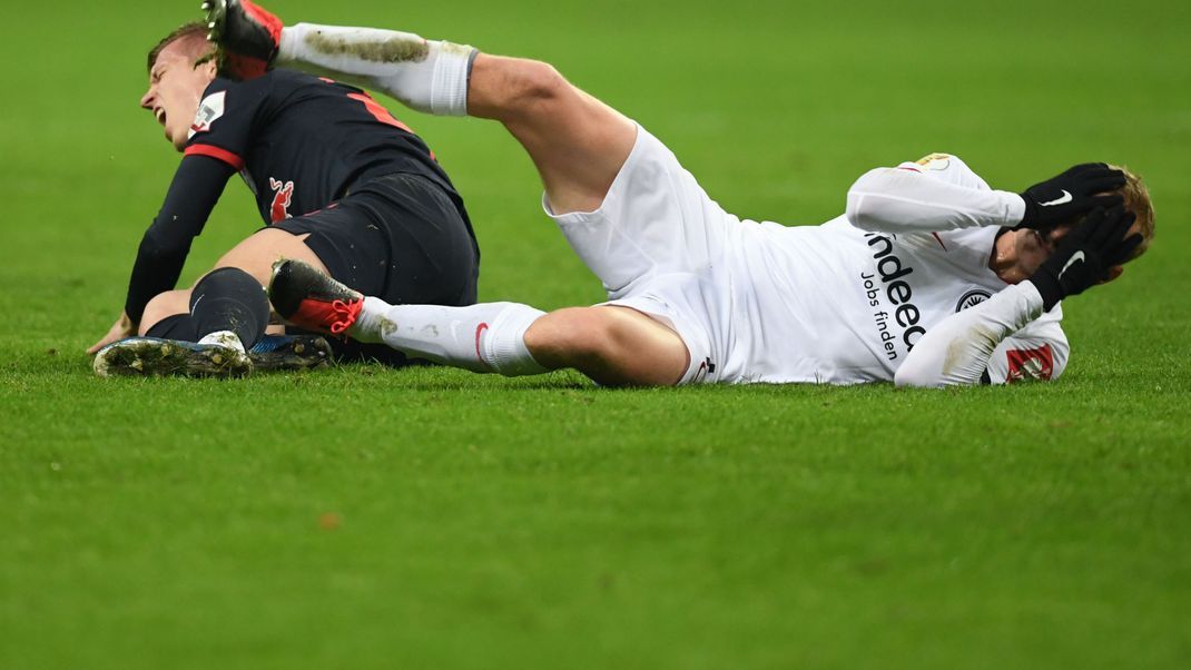 DFB-Pokal, Eintracht Frankfurt gegen RB Leipzig: Sebastian Rode (rechts) greift sich nach einem Zusammenprall mit Dani Olmo an den Kopf. Für den Fall von Kopfverletzungen will die englische Premier League Kurzzeit-Wechsel ermöglichen. 