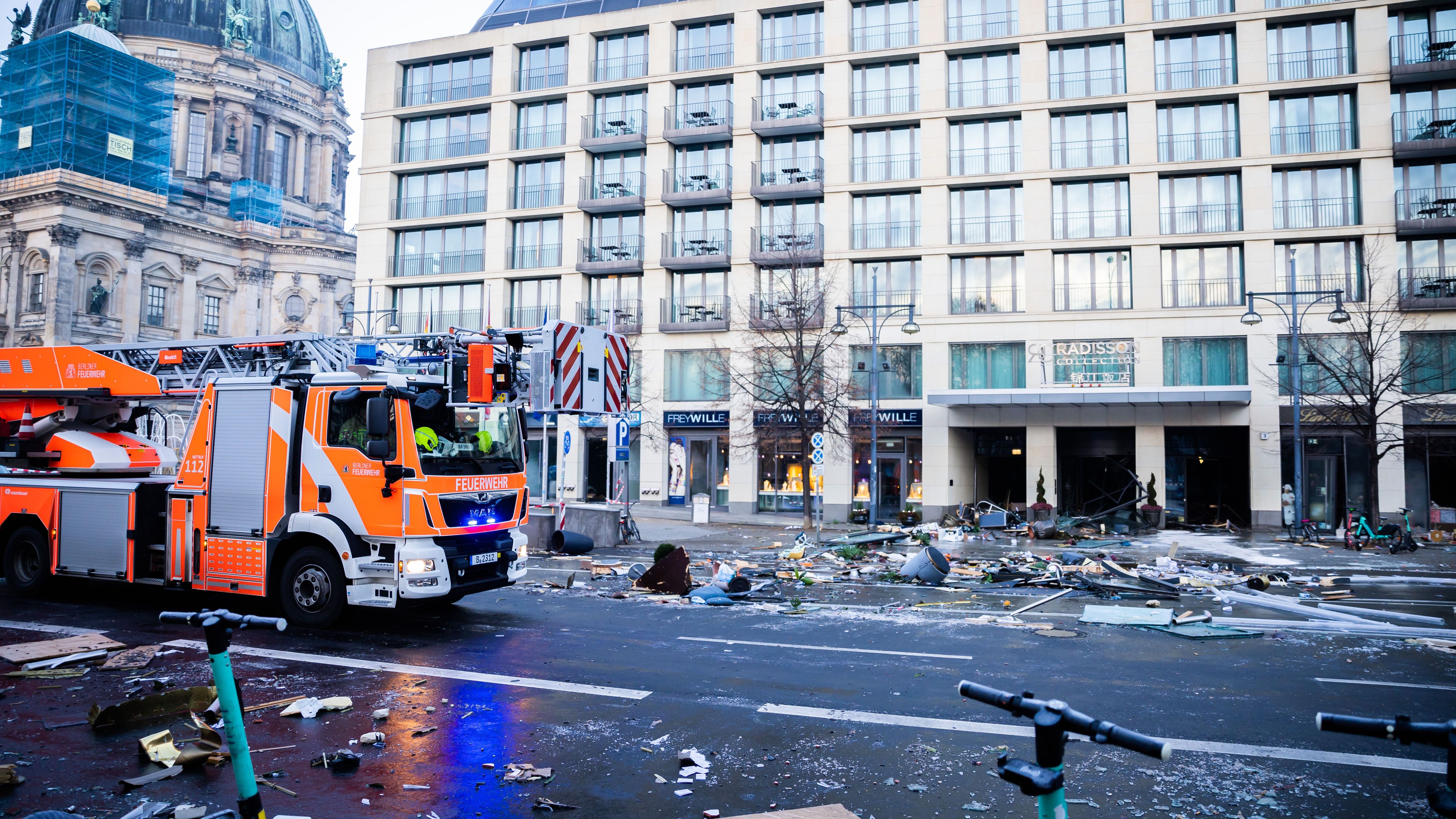 Trümmer liegen vor dem Hotel und die Feuerwehr und Polizei regelt das Chaos. 