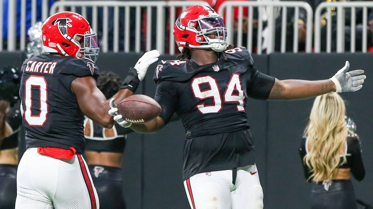 November 26, 2023, Atlanta, Georgia, United States: Atlanta Falcons defensive linemen Albert Huggins (94)(R) and Lorenzo Carter (0) celebrate after a fumble during the game against the New Orleans ...