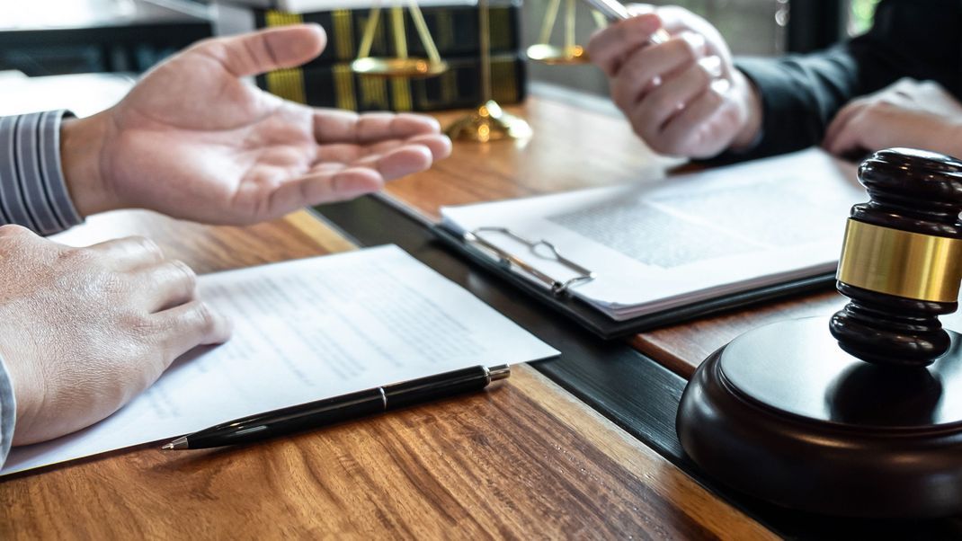 Male lawyer discussing negotiation legal case with client meeting with document contact in courtroom, law and justice concept