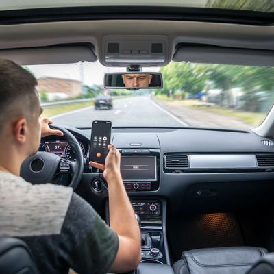 Businessman talking on cell phone while driving.