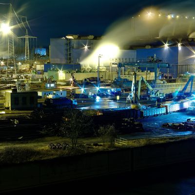 Steel hut in Völklingen in the Saarland in Germany at night in the foreground the Autonahn a620 and the river Saar, the photo shows the production of steel from scrap loaded in railway wagons