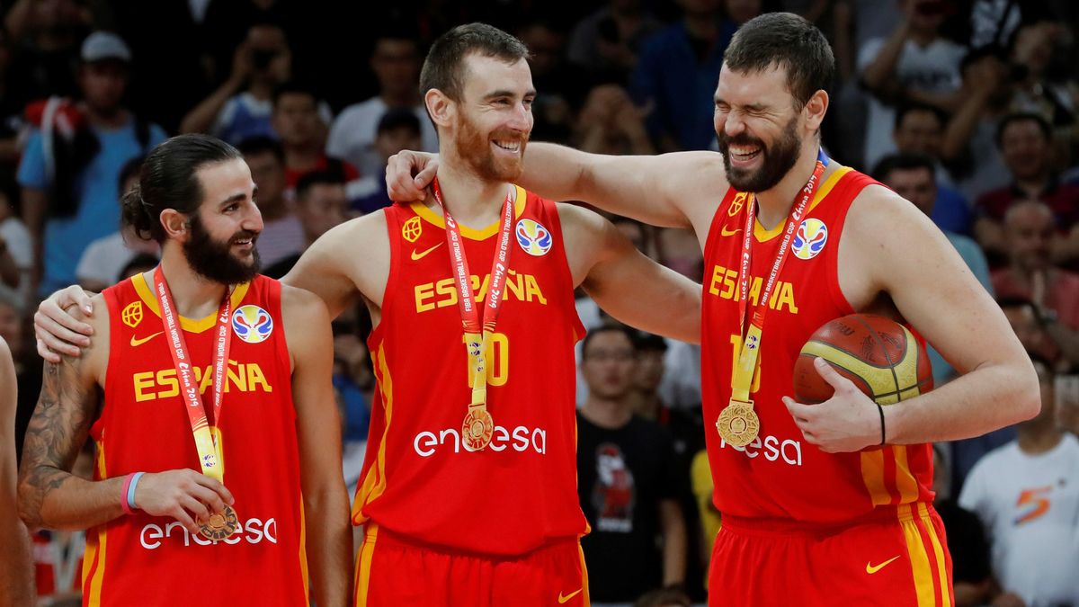 Spain s national basketball team players Ricky Rubio, Victor Claver and Marc Gasol watch their gold medals as they celebrate their victory after the FIBA Basketball World Cup 2019 final match betwe...