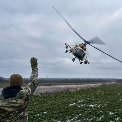 Ein ukrainischer Soldat winkt einem Militärhubschrauber in Cherson zu.