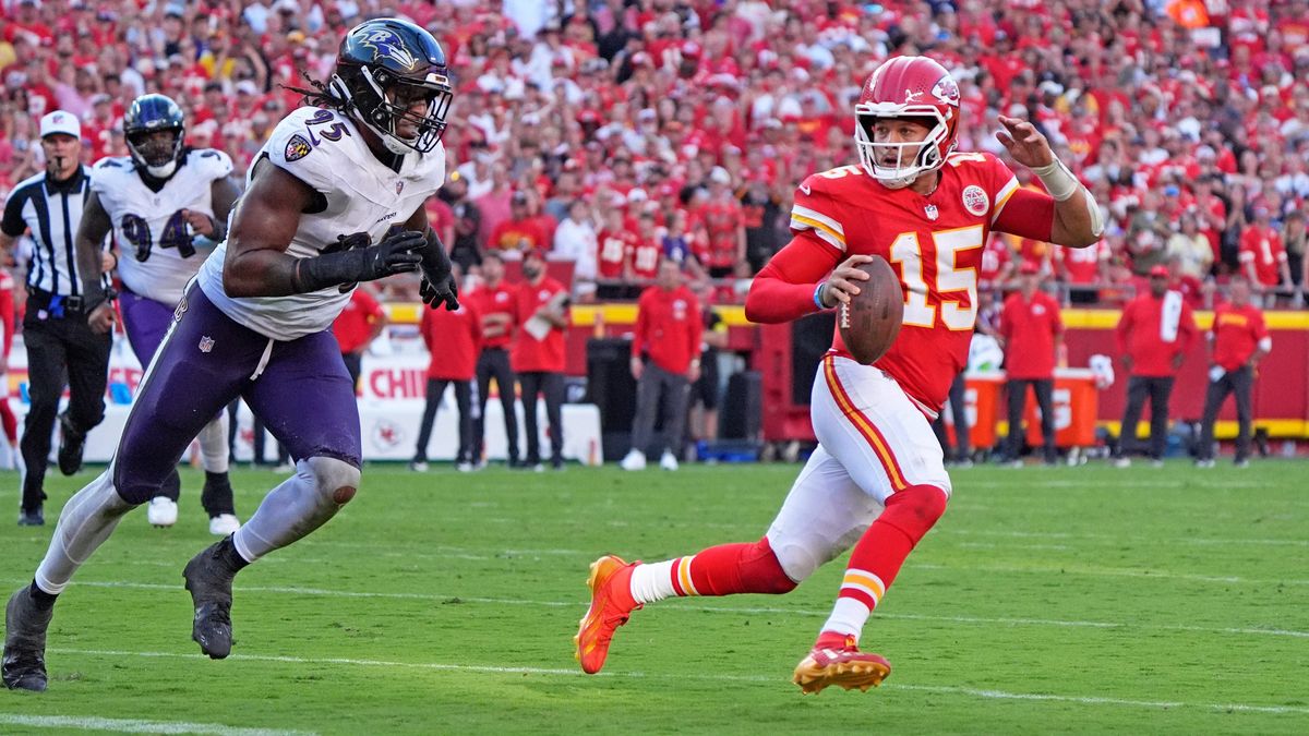 Kansas City Chiefs quarterback Patrick Mahomes (15) in scrambling against Baltimore Ravens linebacker Tavius Robinson (95) ends up throwing an illegal forward pass at Arrowhead Stadium in Kansas Ci...