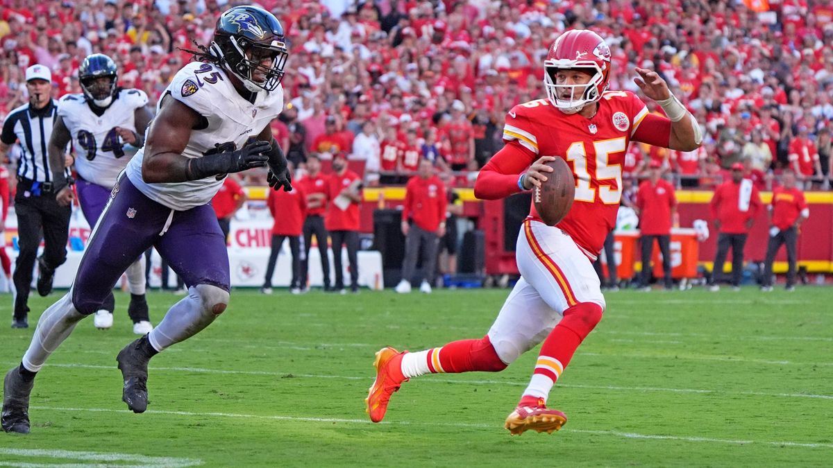 Kansas City Chiefs quarterback Patrick Mahomes (15) in scrambling against Baltimore Ravens linebacker Tavius Robinson (95) ends up throwing an illegal forward pass at Arrowhead Stadium in Kansas Ci...