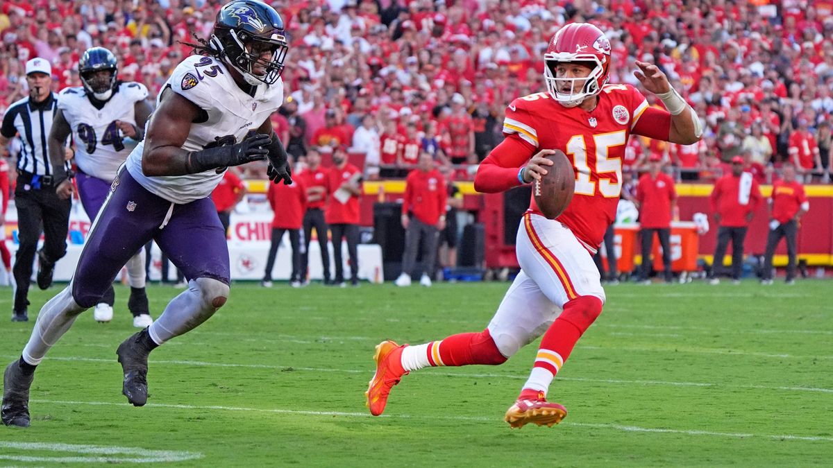 Kansas City Chiefs quarterback Patrick Mahomes (15) in scrambling against Baltimore Ravens linebacker Tavius Robinson (95) ends up throwing an illegal forward pass at Arrowhead Stadium in Kansas Ci...