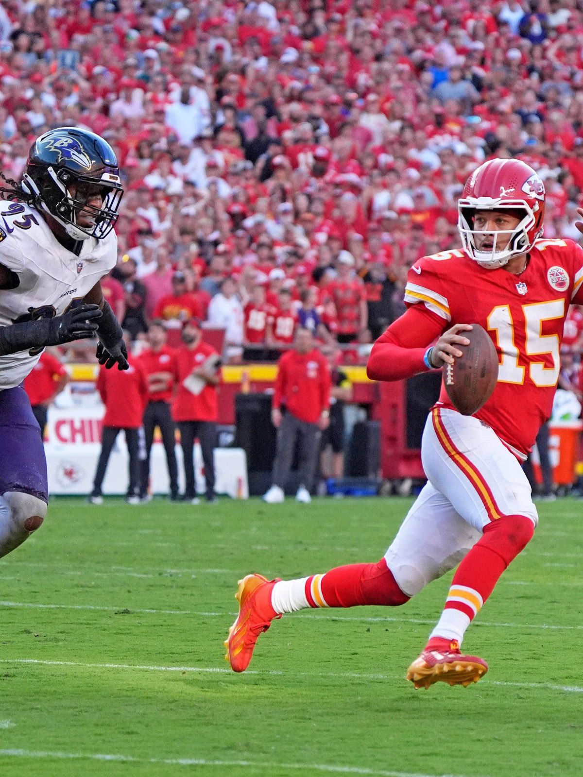 Kansas City Chiefs quarterback Patrick Mahomes (15) in scrambling against Baltimore Ravens linebacker Tavius Robinson (95) ends up throwing an illegal forward pass at Arrowhead Stadium in Kansas Ci...