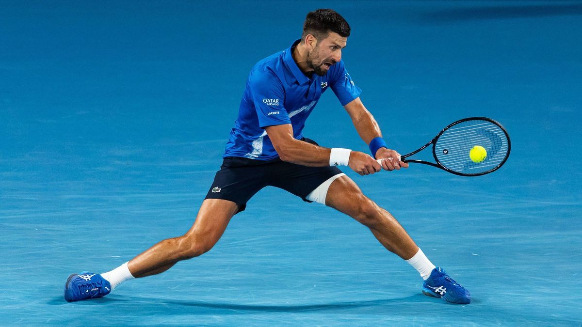 Tennis: Australian Open Jan 22, 2025; Melbourne, Victoria, Australia; Novak Djokovic of Serbia plays a backhand during his match against Carlos Alcaraz of Spain in the quarterfinals of the men s si...