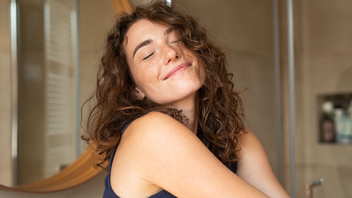 Woman stretching in bathroom after wake up