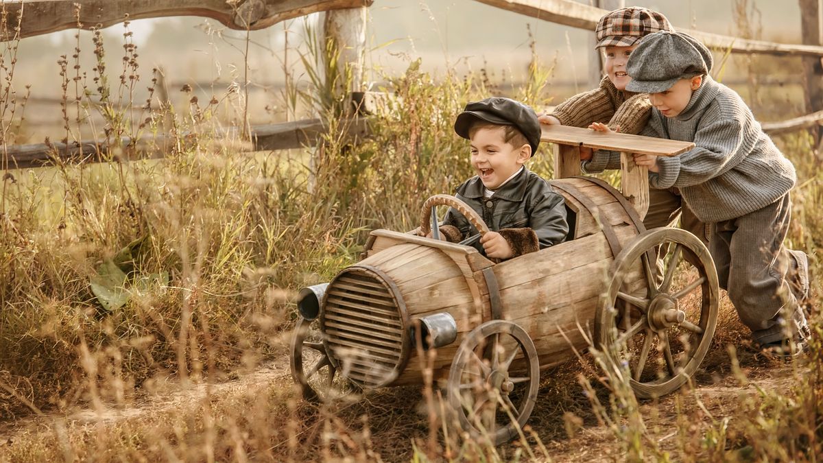 Children on wooden racing car